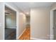 Inviting hallway with hardwood floors leads to spacious rooms, showcasing the home's open layout at 3001 Austin Chaney Rd, Monroe, NC 28110