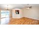 Open-concept living room featuring hardwood floors, vaulted ceilings, ceiling fan, and sliding glass doors to a deck at 3001 Austin Chaney Rd, Monroe, NC 28110