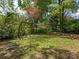 Well-maintained backyard has a swing and rope ladder in the lush forest at 5114 Glenbrier Dr, Charlotte, NC 28212