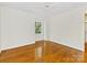 Bright and airy bedroom with hardwood floors and a large window allowing natural light at 5114 Glenbrier Dr, Charlotte, NC 28212