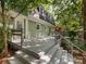 Multi-level deck leads to the home's back entrance with views of the wooded lot at 5114 Glenbrier Dr, Charlotte, NC 28212