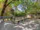 Large deck features built-in benches and wooded backyard views at 5114 Glenbrier Dr, Charlotte, NC 28212