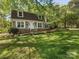 Charming two-story home with a lush green lawn and mature trees providing ample shade at 5114 Glenbrier Dr, Charlotte, NC 28212