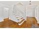 Bright foyer with hardwood floors and a staircase with decorative iron railings at 5114 Glenbrier Dr, Charlotte, NC 28212