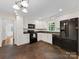 Well-maintained kitchen featuring white cabinets, dark appliances, and unique tile flooring at 5114 Glenbrier Dr, Charlotte, NC 28212