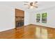 Bright living room with a brick fireplace and a large window offering natural light at 5114 Glenbrier Dr, Charlotte, NC 28212