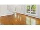 Sun-filled living room featuring gleaming hardwood floors and large windows at 5114 Glenbrier Dr, Charlotte, NC 28212