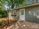 Separate outbuilding with brick-paver front entry, window boxes, and white trim at 5114 Glenbrier Dr, Charlotte, NC 28212