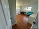 A bedroom with light green walls, wood laminate floors, a built-in desk and a window at 5226 Indian Trail Fairview Rd, Indian Trail, NC 28079