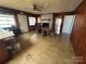 Dining room with wood paneled walls, a ceiling fan, and a decorative fireplace at 5226 Indian Trail Fairview Rd, Indian Trail, NC 28079