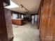 The kitchen features a skylight and track lighting above a large peninsula with wooden cabinetry at 5226 Indian Trail Fairview Rd, Indian Trail, NC 28079