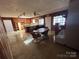 A kitchen with wood paneled walls, wood cabinets, and a view into the dining room at 5226 Indian Trail Fairview Rd, Indian Trail, NC 28079