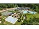 Aerial view of community amenities, including a pool, playground, tennis courts, and basketball court, surrounded by greenery at 6398 Chimney Bluff Rd, Lancaster, SC 29720