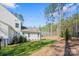 Exterior view of the backyard featuring a lawn, trees, and the side of the white house at 6398 Chimney Bluff Rd, Lancaster, SC 29720