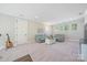 Finished basement with plush carpeting, comfortable seating, and plenty of natural light from multiple windows at 6398 Chimney Bluff Rd, Lancaster, SC 29720