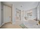Bright bathroom featuring a soaking tub, glass-enclosed shower, and double vanity sink with modern fixtures at 6398 Chimney Bluff Rd, Lancaster, SC 29720