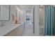 Modern bathroom with double vanity, granite countertops, and a shower with a stylish blue curtain at 6398 Chimney Bluff Rd, Lancaster, SC 29720