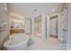 Bright bathroom featuring a soaking tub, glass shower, double vanity, and neutral tile at 6398 Chimney Bluff Rd, Lancaster, SC 29720