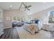 Bright bedroom showcasing a seating area, large windows, and hardwood flooring at 6398 Chimney Bluff Rd, Lancaster, SC 29720