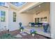 Covered patio extends outdoor living, complete with comfortable seating, overlooking beautiful landscaping and a wooded backdrop at 6398 Chimney Bluff Rd, Lancaster, SC 29720