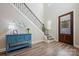 Inviting foyer with wood floors, staircase, stylish decor, and a glass-paneled front door at 6398 Chimney Bluff Rd, Lancaster, SC 29720