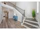Elegant foyer features a staircase with wood and iron banisters, hardwood floors, and ample natural light at 6398 Chimney Bluff Rd, Lancaster, SC 29720