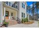 Charming front porch with brick steps, a small bench, and black iron railings, with mature trees and greenery around at 6398 Chimney Bluff Rd, Lancaster, SC 29720