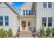 Inviting front porch with brick steps, potted plants, and a cozy seating area at 6398 Chimney Bluff Rd, Lancaster, SC 29720