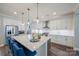 Bright and modern kitchen with stainless steel appliances, a large island, and stylish pendant lighting at 6398 Chimney Bluff Rd, Lancaster, SC 29720