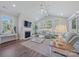 Bright living room featuring a fireplace, vaulted ceilings, and large windows with views of wooded area at 6398 Chimney Bluff Rd, Lancaster, SC 29720