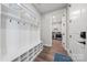 Well-organized mud room with coat hooks, storage bench, and easy access to laundry room and exterior at 6398 Chimney Bluff Rd, Lancaster, SC 29720