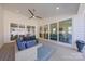 Covered porch with stylish blue patio furniture, ceiling fan, and view of outdoor living at 6398 Chimney Bluff Rd, Lancaster, SC 29720