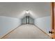Finished attic space with neutral carpet and blue walls at 7146 Sifford Rd, Stanley, NC 28164