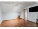 Bonus room with hardwood floors and a large TV at 7146 Sifford Rd, Stanley, NC 28164
