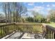 Enjoy the deck with its serene view of the property's expansive, tree-lined backyard at 7146 Sifford Rd, Stanley, NC 28164
