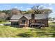 Brick home with a fenced backyard, deck, and covered porch at 7146 Sifford Rd, Stanley, NC 28164