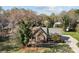 Brick home featuring mature landscaping, an American flag, and a spacious driveway at 7146 Sifford Rd, Stanley, NC 28164