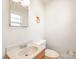 Basic bathroom with essential fixtures and natural light at 7207 Idlewild Rd, Charlotte, NC 28212