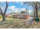 Cozy brick home with a fenced yard, mature trees, and a convenient back entrance at 7207 Idlewild Rd, Charlotte, NC 28212