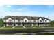 A row of attractive townhomes features painted white brick, black trim, and matching black front doors at 8654 Miles Gap Rd, Indian Land, SC 29707