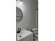 Modern bathroom features sleek vanity, round mirror and a stylish faucet at 11011 Park Rd, Charlotte, NC 28226