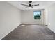 Neutral bedroom featuring gray carpeting, a ceiling fan, and a sunlit window at 11712 Battery Pl, Charlotte, NC 28273