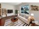 Stylish living room featuring a large window, modern furniture, and decorative shelving at 11712 Battery Pl, Charlotte, NC 28273