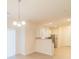 Dining area with a modern chandelier opens to the kitchen with granite countertops and stainless steel appliances at 2009 Amos Oaks Ln, Charlotte, NC 28215