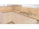 Close up of the kitchen sink, granite countertops, white cabinets, and stainless steel appliances at 2009 Amos Oaks Ln, Charlotte, NC 28215