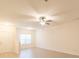 Bright living room with modern ceiling fan, neutral walls, and light-colored flooring at 2009 Amos Oaks Ln, Charlotte, NC 28215