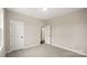 Bedroom featuring neutral walls, carpet, white trim, and two doors leading to other rooms at 2017 Belle Grove Dr, Waxhaw, NC 28173