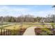 Landscaped front yard featuring a walkway leading to other homes with plenty of foliage and trees at 2017 Belle Grove Dr, Waxhaw, NC 28173