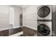 Modern laundry room featuring stackable washer and dryer and wire shelving at 2017 Belle Grove Dr, Waxhaw, NC 28173