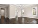 Bright living room with dark wood floors and chandelier at 2017 Belle Grove Dr, Waxhaw, NC 28173